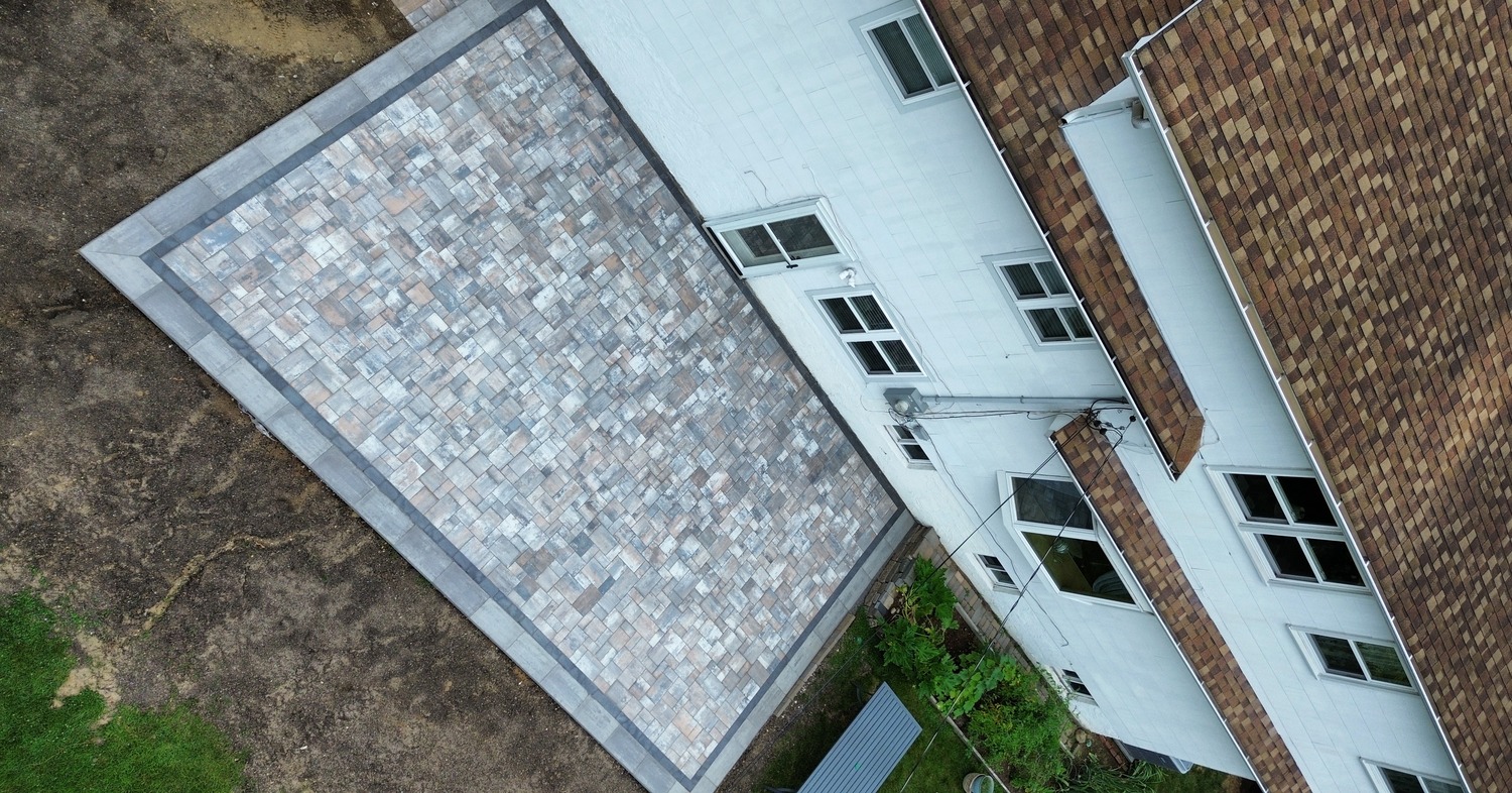 A newly installed backyard paver surface reflecting the paver patio cost in Dover.