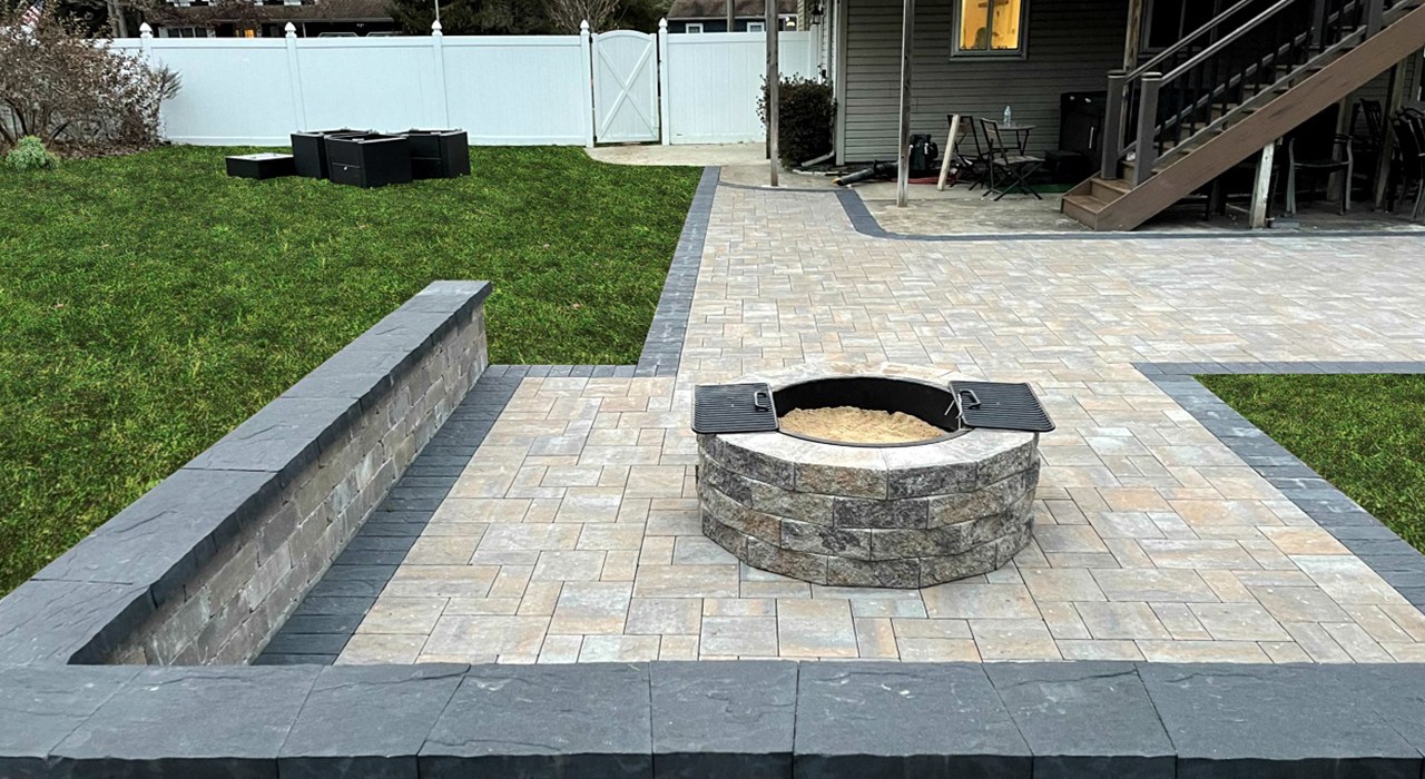 A custom fire pit paired with a raised stone bench for creative seating wall ideas