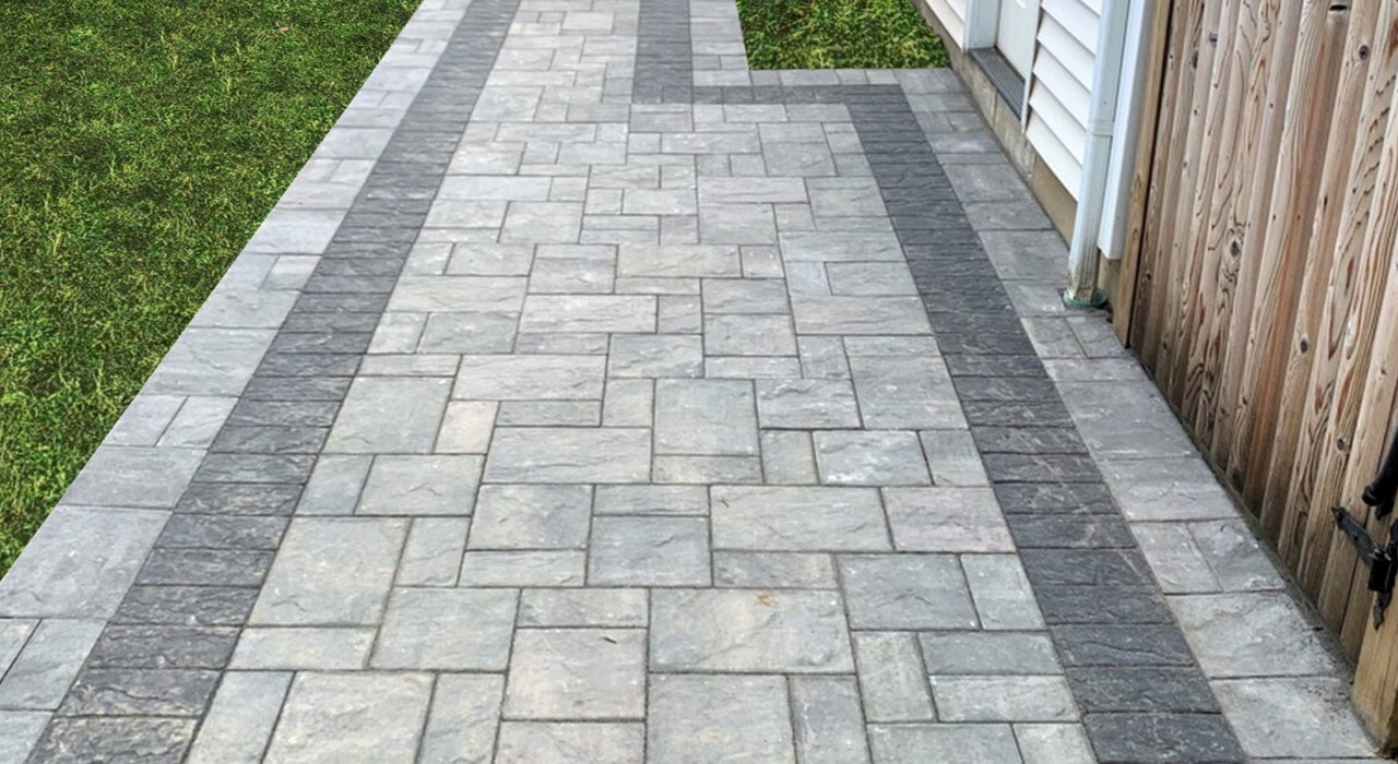 A newly installed grey interlocking stone path detailing a typical walkway renovation cost