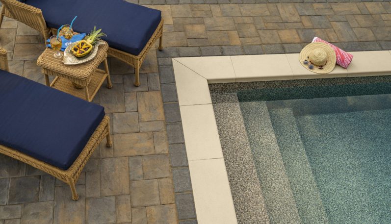 Affordable patio A flagstone path meanders through a backyard oasis, passing by a sparkling pool and lush greenery.
